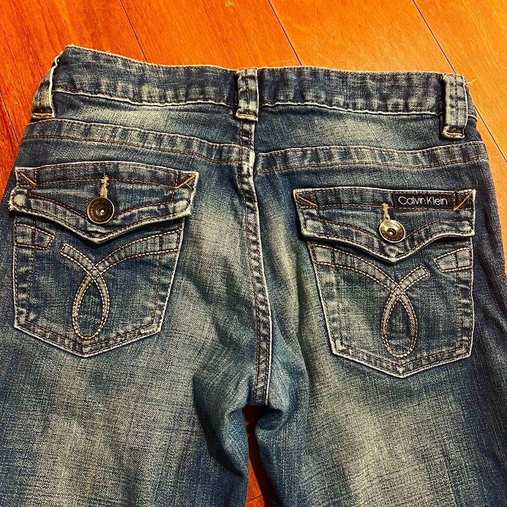 Calvin Klein jeans bootcut with beautiful designed pockets & gold bronze buttons